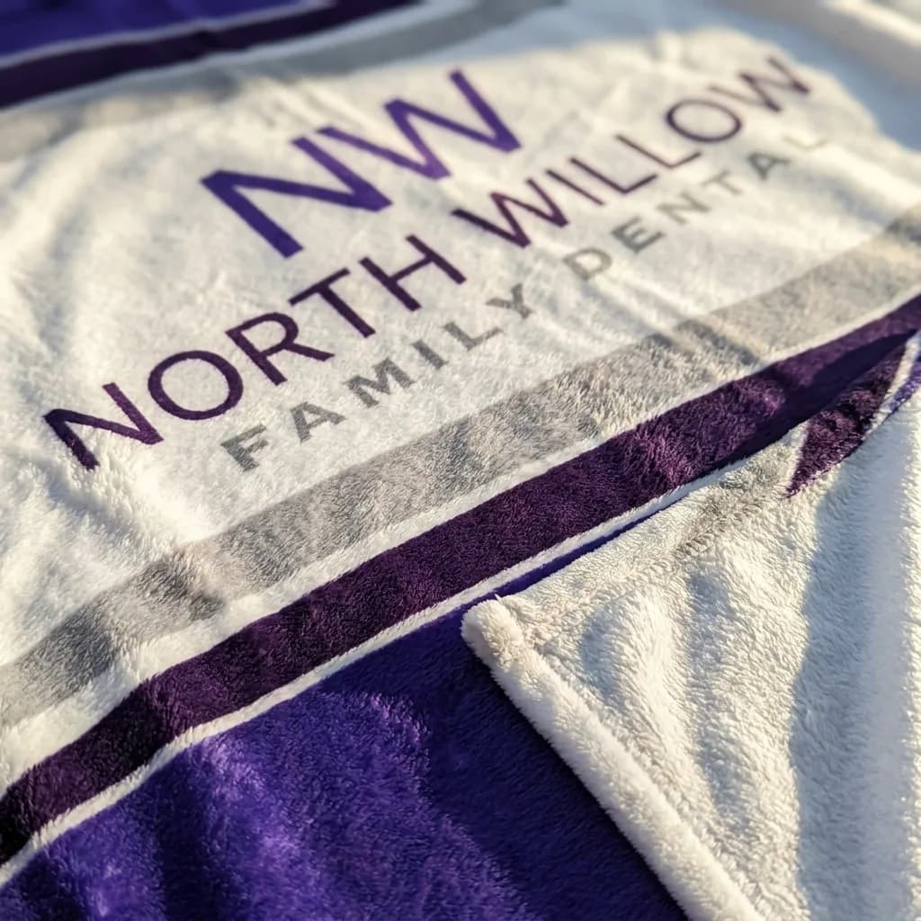 Close-up of the practice logo printed crisply into dense plush fabric